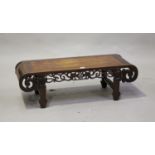 A Chinese hardwood low table, early 20th century, the rectangular panelled top with scroll ends