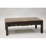 A Chinese hardwood rectangular low table, early 20th century, the panelled top above a shaped