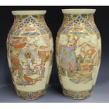 A pair of Japanese Satsuma earthenware vases, Meiji period, each painted and gilt with panels of