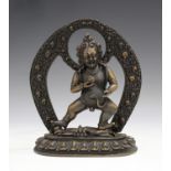 A Sino-Tibetan brown patinated sectional figure of Jambhala, 20th century or later, the god of