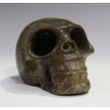 A carved brown stone skull, probably Tibetan, length 14.8cm.Buyer’s Premium 29.4% (including VAT @