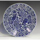 A Chinese blue and white porcelain circular dish, late 19th century, painted with two dragons amidst