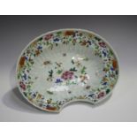 A Chinese famille rose export porcelain barber's bowl, Qianlong period, of fluted oval form, painted