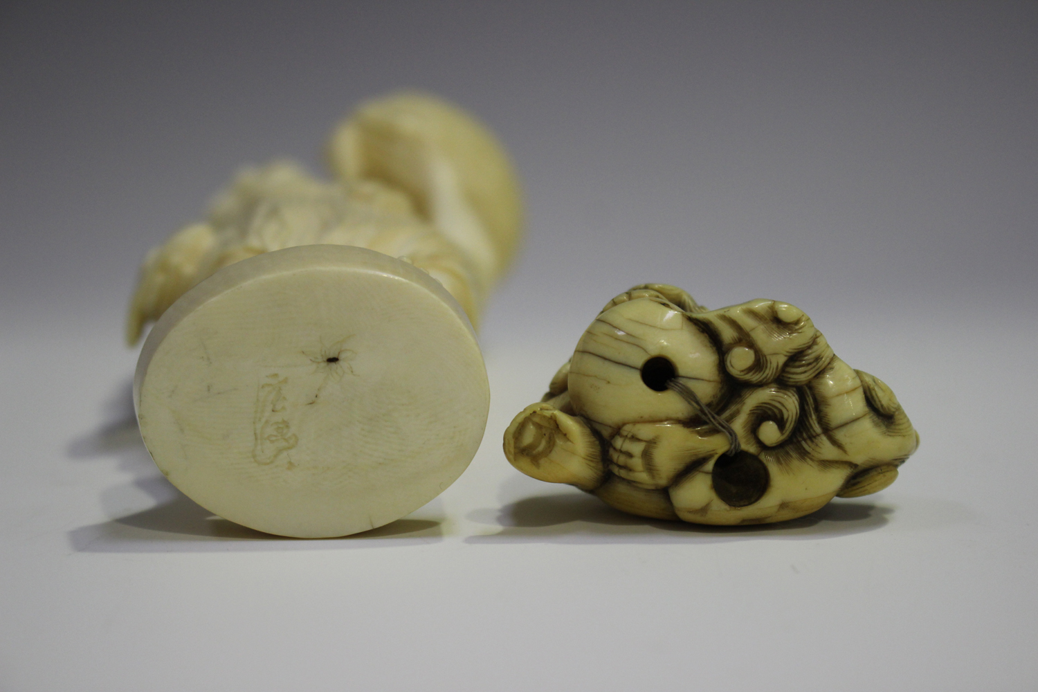 A Japanese carved ivory okimono netsuke, 19th century, modelled as a Buddhistic lion with left paw - Image 5 of 8