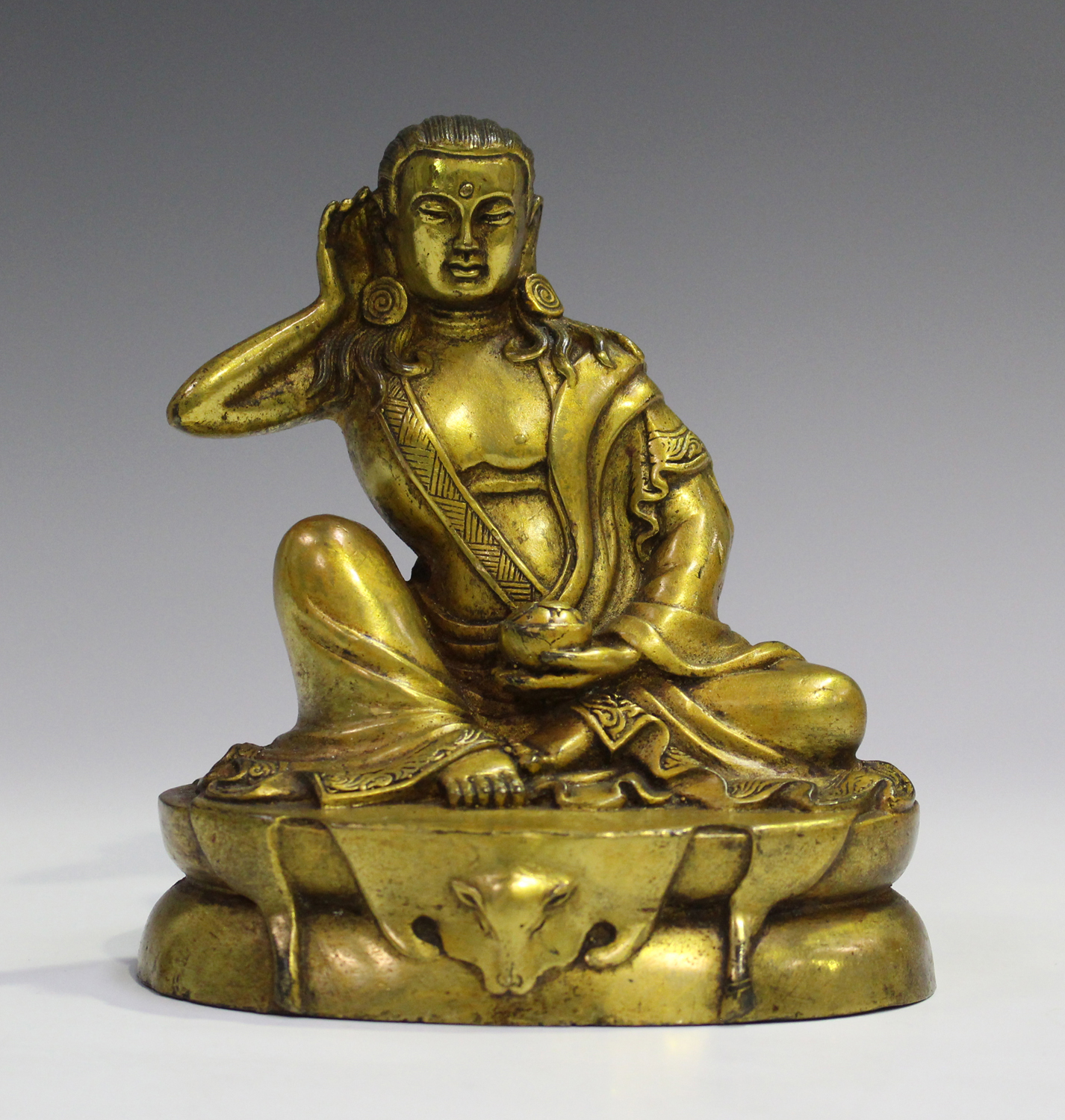A Sino-Tibetan gilt bronze bodhisattva, probably 20th century, modelled seated on an oval throne,