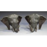 A pair of Japanese brown patinated bronze elephant head bookends, late Meiji period, each modelled