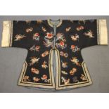 A Chinese midnight blue silk embroidered short jacket, late Qing dynasty, finely worked in