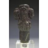 A Nepalese carved stone handle/pommel, possible 17th century, carved in relief with four heads of