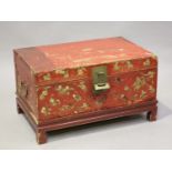 A Chinese red lacquered vellum trunk, late Qing dynasty, the front and sides gilt with figures and