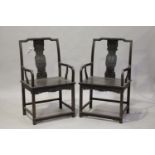 A pair of Chinese hardwood armchairs, 20th century, each shaped top rail above a splat back,