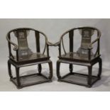 A pair of Chinese hardwood horseshoe back armchairs, 20th century, each splat back with pierced