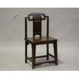 A Chinese hardwood chair, late Qing dynasty, the shaped top rail above a splat back with shou