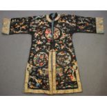 A Chinese black silk embroidered robe, early 20th century, worked in coloured threads with an