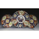 A Japanese Imari porcelain dish, early 20th century, of lobed form, painted with panels of flowers