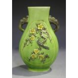 A Chinese famille verte enamelled biscuit porcelain vase of hu form, each side moulded in relief