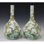 A pair of Chinese famille verte porcelain bottle vases, Kangxi style but modern, each painted with a