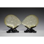 A pair of Chinese carved and pierced mother-of-pearl shells, 20th century, each decorated with a