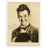 AUTOGRAPHS. Two signed black and white photographs, one of Stan Laurel, the other of Oliver Hardy,
