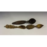 A group of three Middle Eastern carved wooden ladles, the flattened handles with pierced and