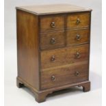 A small George III mahogany commode cabinet, the moulded top above two doors and two drawers, height