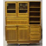 A mid-20th century teak side cabinet, fitted with shelves, glazed cabinets, drawers and cupboards,