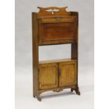 An Edwardian Arts and Crafts oak student's bureau, in the manner of Liberty & Co, the fall-flap