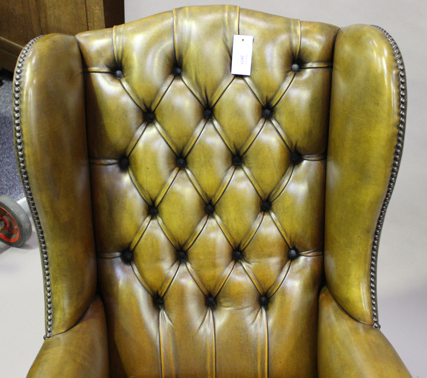 A 20th century George III style wing back armchair, upholstered in buttoned khaki leather, on - Image 3 of 3