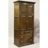 A modern 18th century style solid oak wardrobe by Bylaw, fitted with a pair of panelled doors