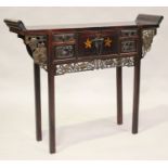 A 20th century Chinese stained softwood altar table, fitted with central cupboard flanked by drawers