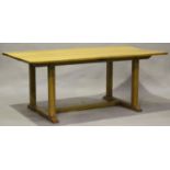 An early/mid-20th century Arts and Crafts style pale oak refectory table, on block legs and