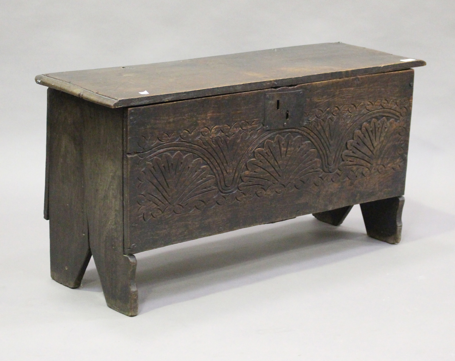 A late 17th century oak six plank boarded coffer, the front with later carved decoration, height