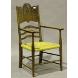 An early 20th century Arts and Crafts oak and ash elbow chair, in the manner of William Birch, the