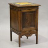 An Edwardian Arts and Crafts oak bedside cabinet, the top inset with yellow and green glazed ceramic