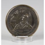A 19th century Scottish pressed horn circular snuff box and cover, the lid decorated with a titled