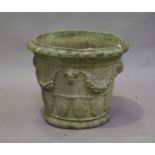 A 20th century cast composition stone garden planter, the tapering body cast with masks, grape swags