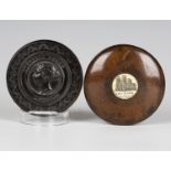 A Victorian carved lignum vitae circular snuff box and cover, the lid decorated with a titled and