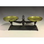 A set of late 19th century cast iron kitchen balance scales, fitted with brass pans, width 78cm,