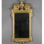 A fine George II style carved giltwood and gesso wall mirror, probably 19th century, the shaped