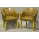 A pair of modern brown leather tub back easy chairs, on beech block legs, height 78cm, width 63cm,