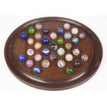 A group of thirty-two glass marbles, including 19th century examples, some with internal latticino