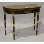A Regency rosewood and satinwood crossbanded fold-over card table with boxwood stringing and applied