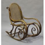 A late 19th/early 20th century bentwood rocking armchair, in the manner of Thonet, height 93cm,