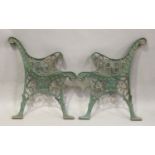 A pair of early 20th century green painted cast iron garden bench ends, height 72cm, depth 61cm.