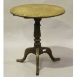 A 19th century provincial oak circular tip-top wine table, raised on tripod legs, height 67cm,