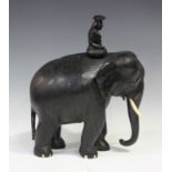 A late 19th/early 20th century Indian carved ebony model of an elephant and rider, height 40cm,