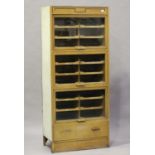 An early 20th century oak fronted haberdashery cabinet by Dudley & Co Ltd, fitted with three