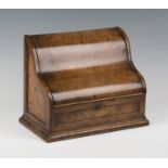 A mid-Victorian burr walnut stationery box, the hinged serpentine lid enclosing a letter rack,