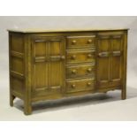 An Ercol elm sideboard, fitted with drawers and cupboards, height 90cm, width 146cm, depth 51.5cm.