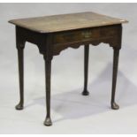 A George III oak side table, fitted with a single frieze drawer above a fretwork apron, on turned
