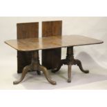 A modern 18th century style solid oak twin-pedestal dining table by Bylaw, the top with two extra